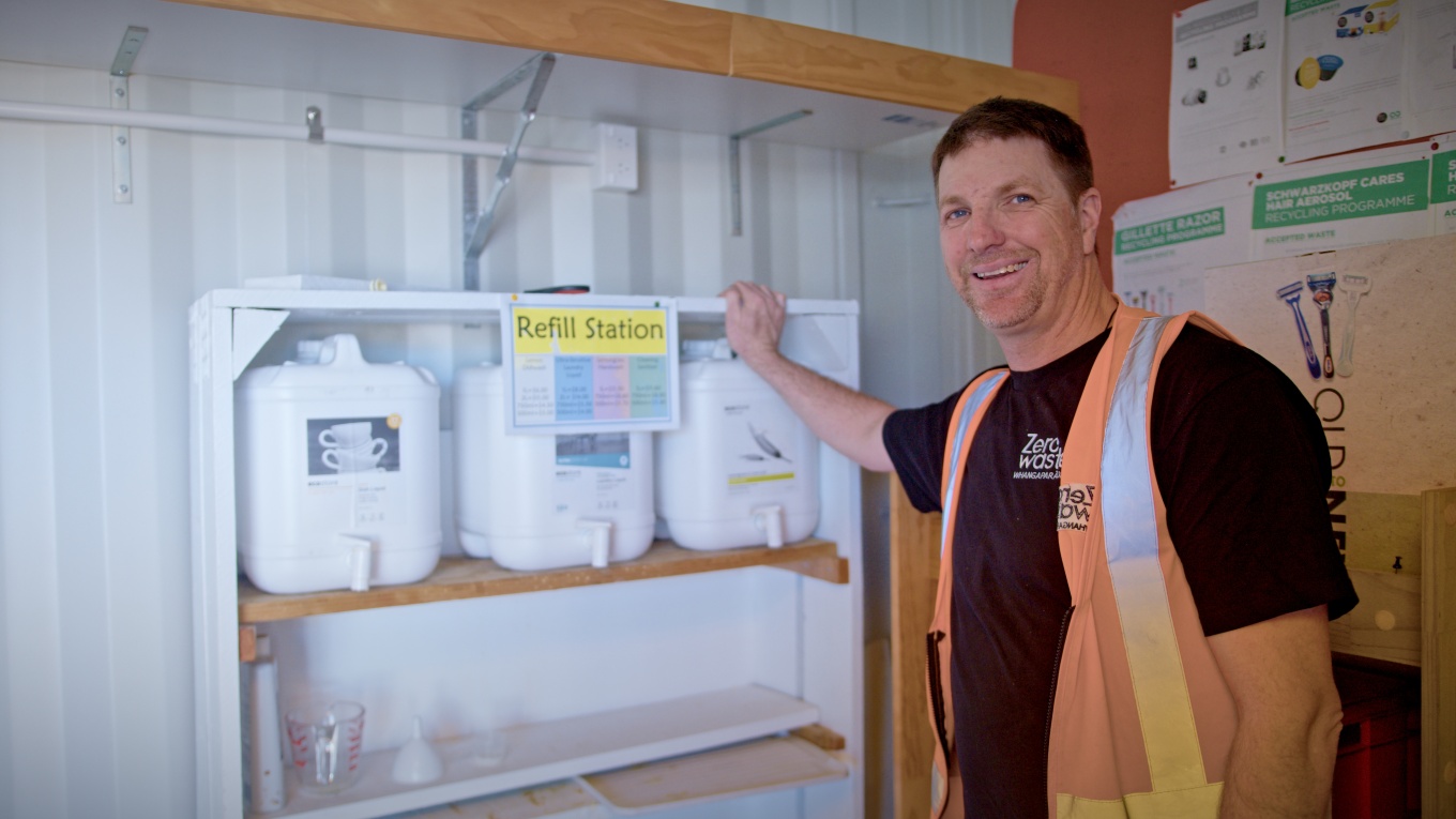 A worker next to a refill station. 