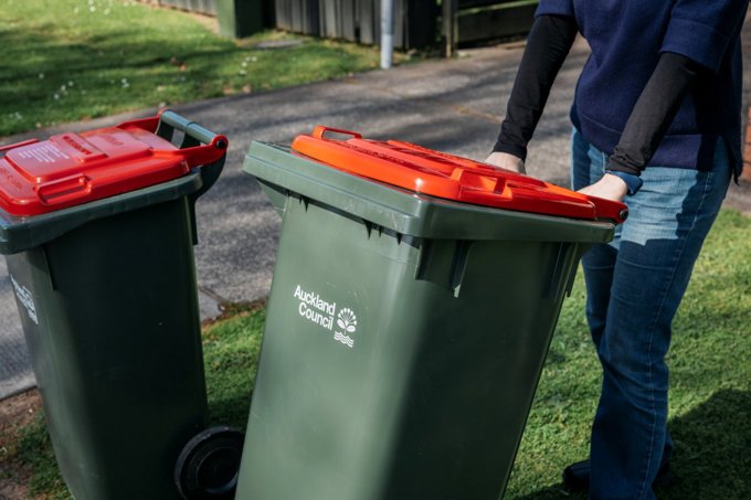 Auckland Council red-lidded rubbish bins wheeled out
