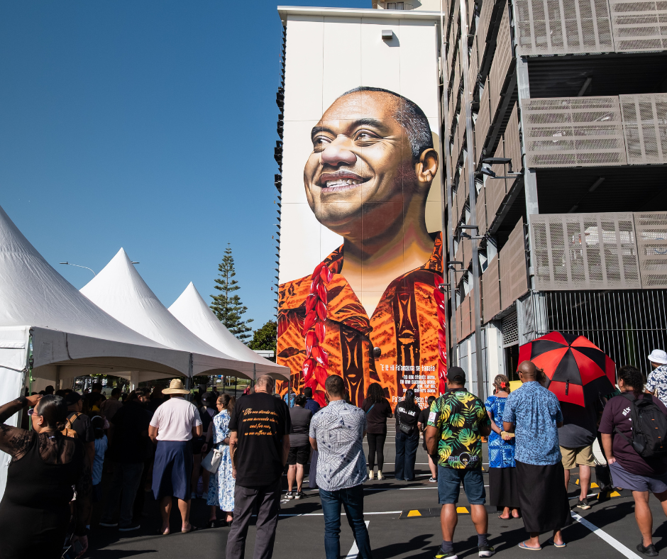 Crowd gathering for the mural unveiling.