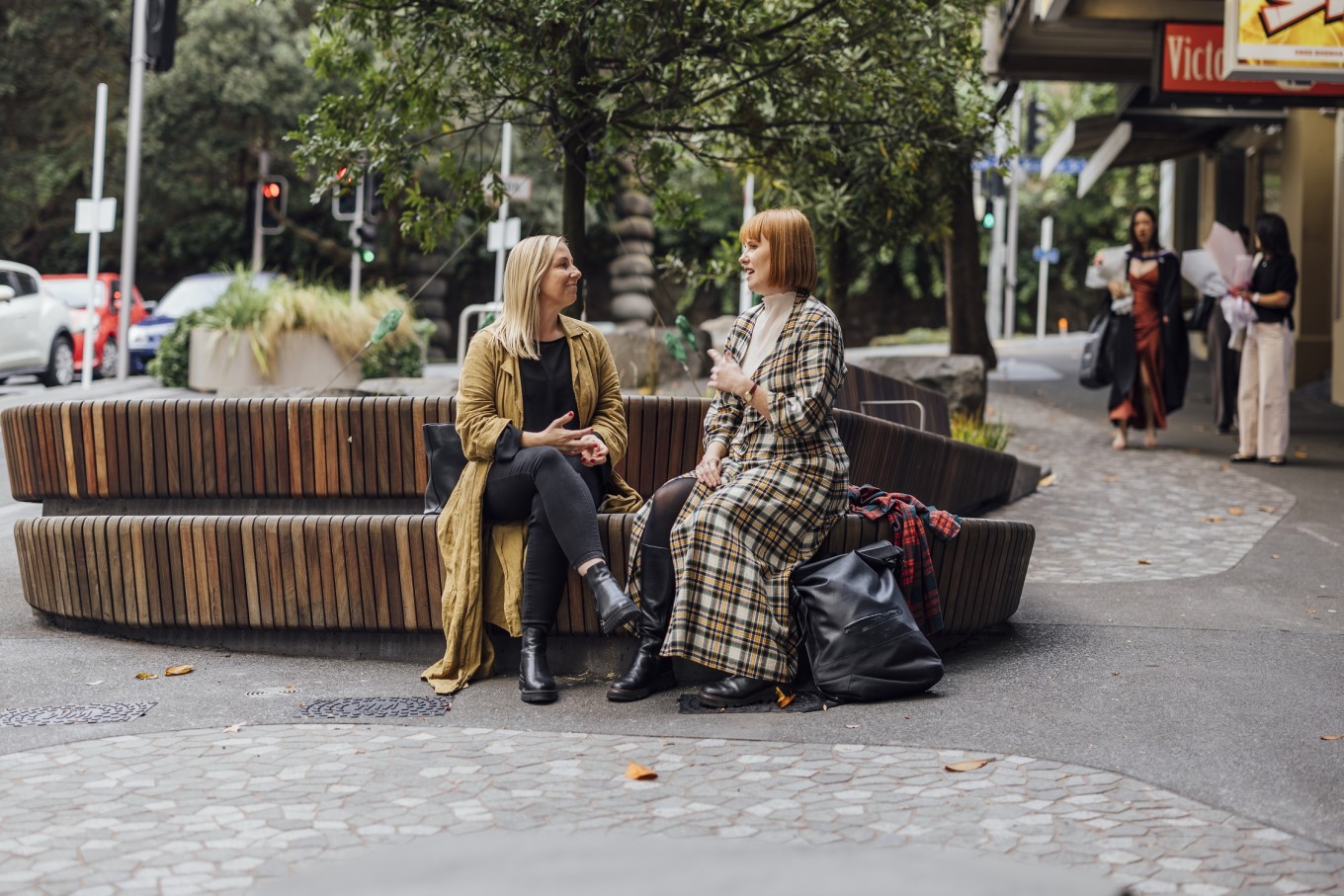 Two ladies sitting on Victoria St.