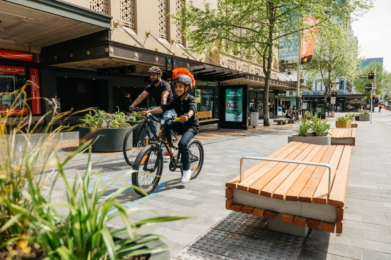 People riding bikes down an urban street. 