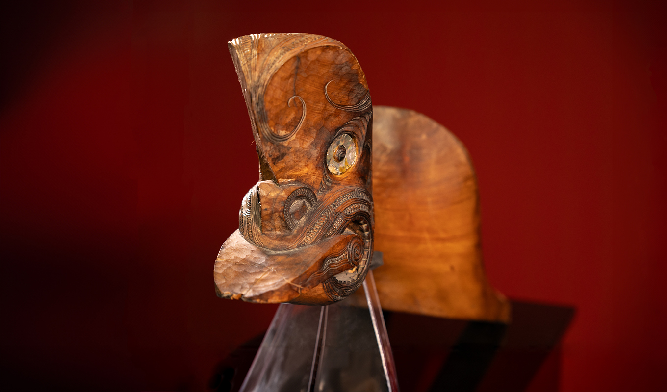 A wooden whakairo Māori (Māori carving) from the Waiwaia Ngā Ngutu exhibition on at Auckland Central City Library.