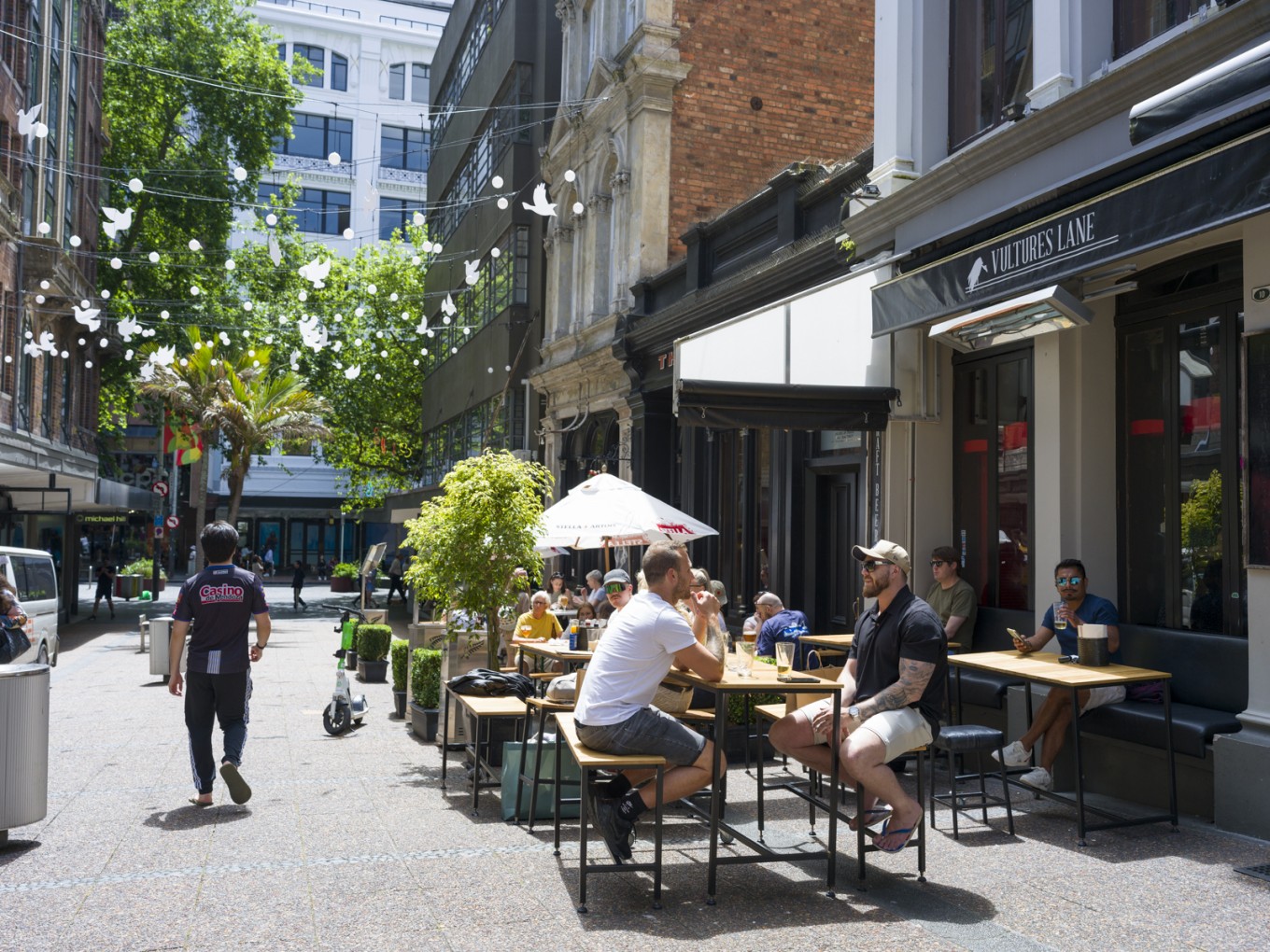 People enjoying businesses in Vulcan Lane. 