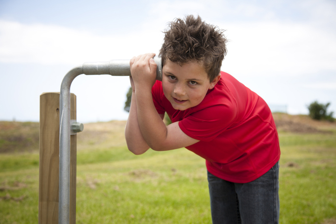 A child next to a pipe