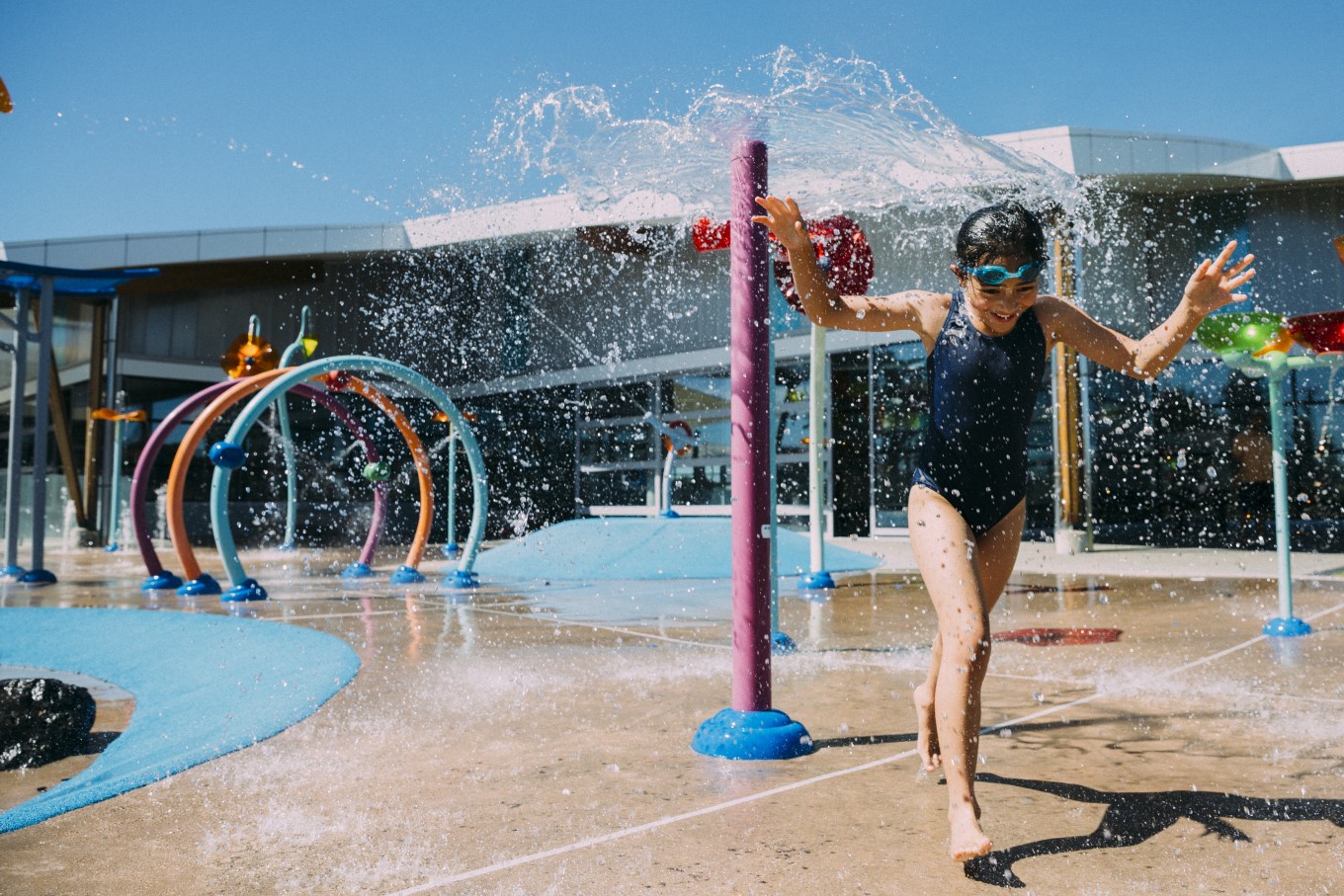 A girl playing at Otahuhu Pool and Leisure Centre Splashpad. 