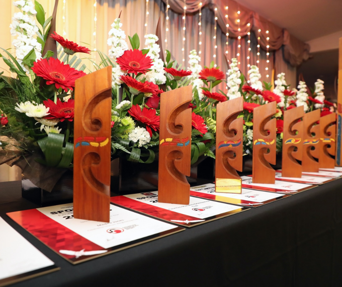Māori wooden design awards lined up on table