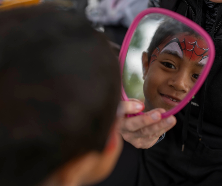 Child with Spider Man face paint on.