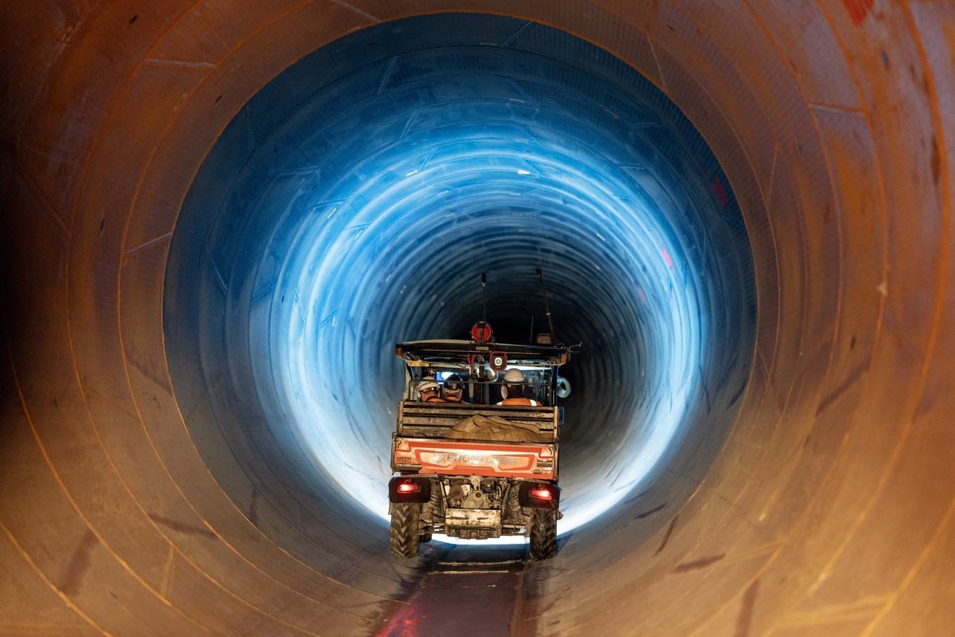 A vehicle driving down a tunnel.
