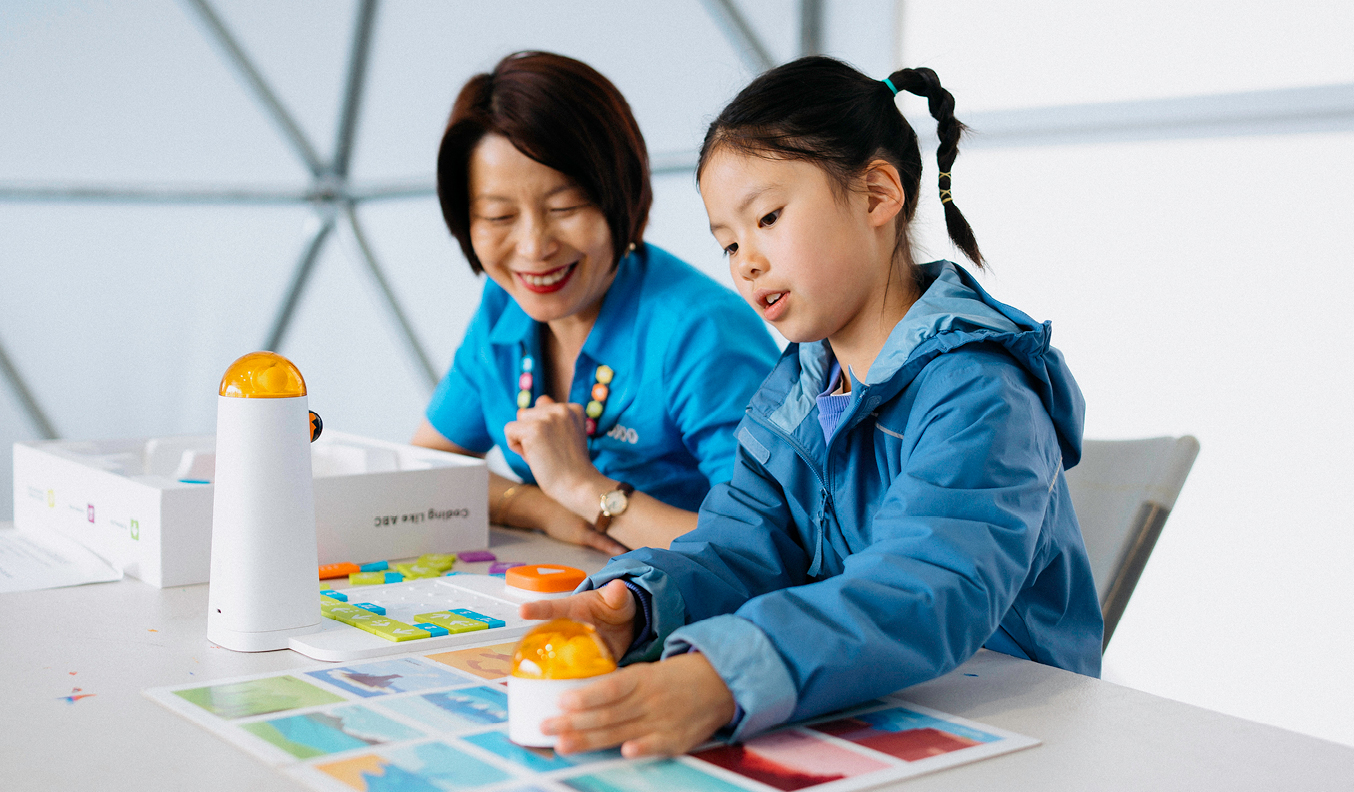 A woman and a kid playing board games.