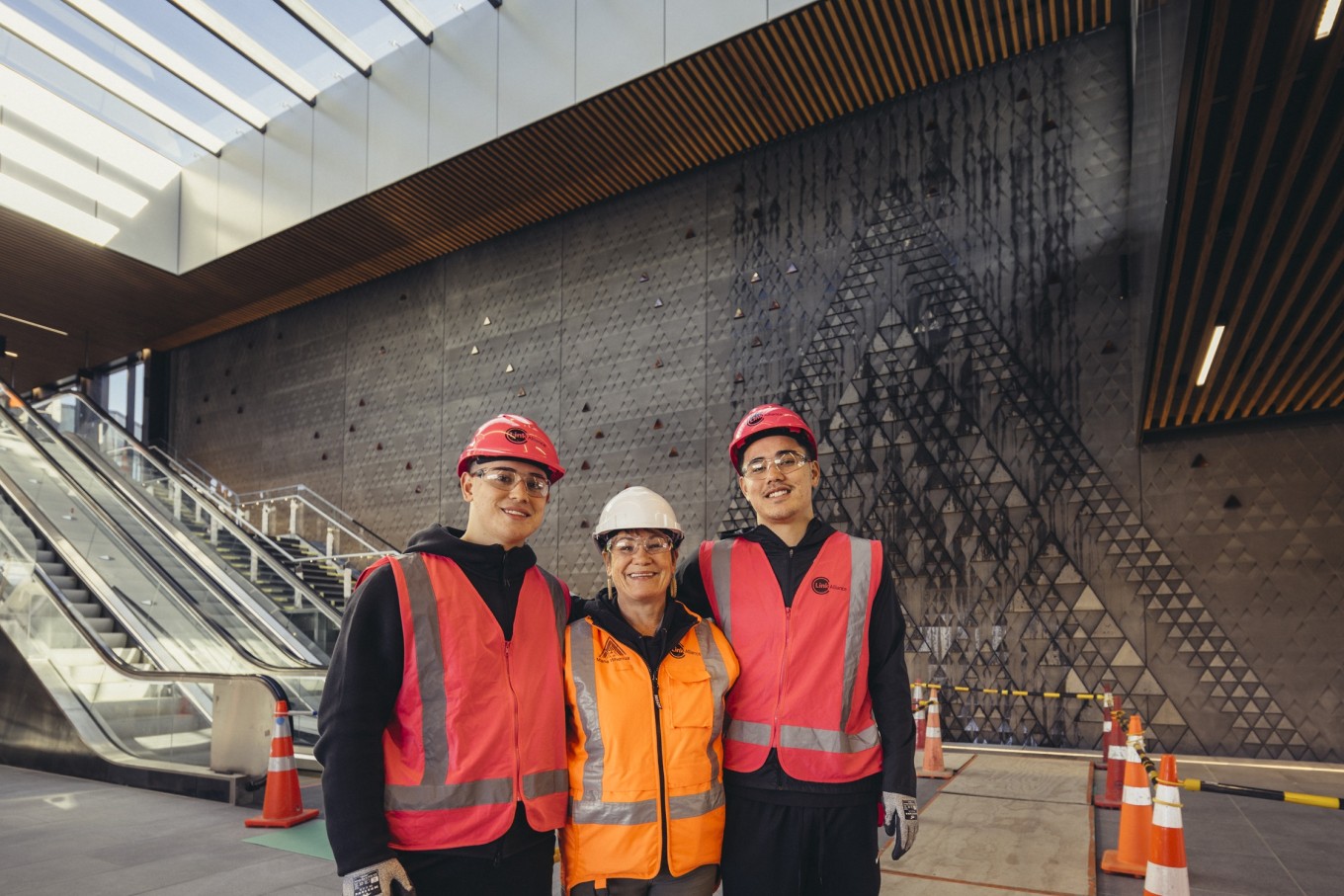 Maungawhau Station artist Tessa Harris with her sons Kalani Ah Sue (left) and Kian Ah Sue (right) in the station.