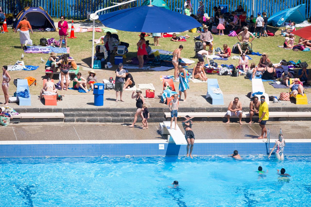 People enjoying good weather at the pools. 