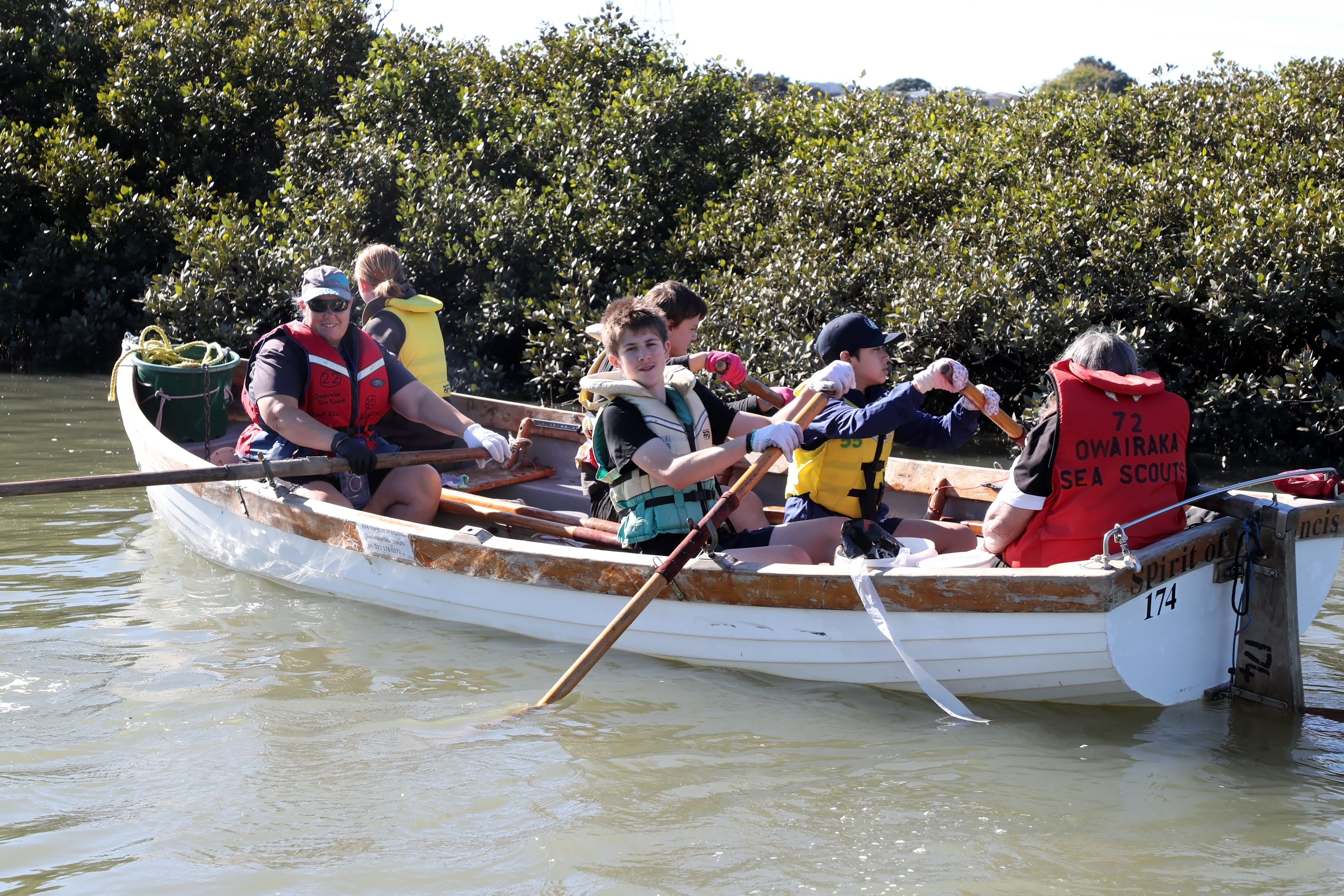 Kids rowing in a boat.