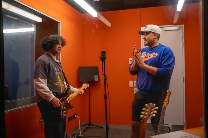 Joshua Faletutulu and student in the studio